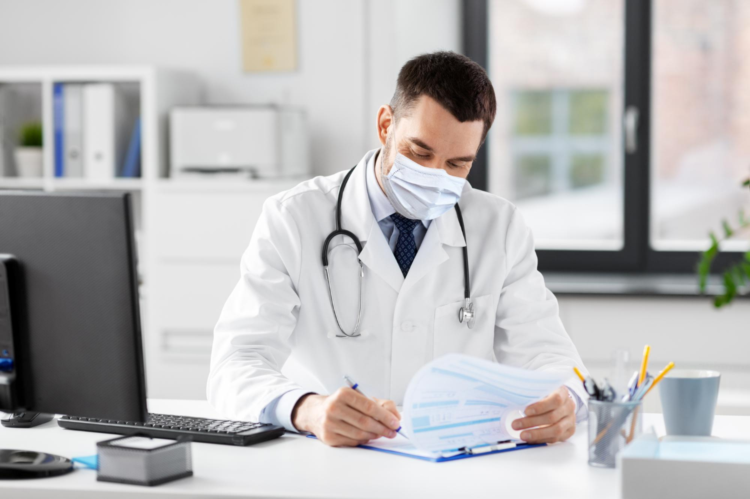 Male doctor holding a clipboard in a hospital during the great resignation.