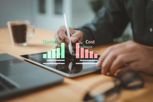 Businessman uses a tablet to manage cost and quality control, importance of effective business strategies and project management. The quality control growth graph and cost reduction