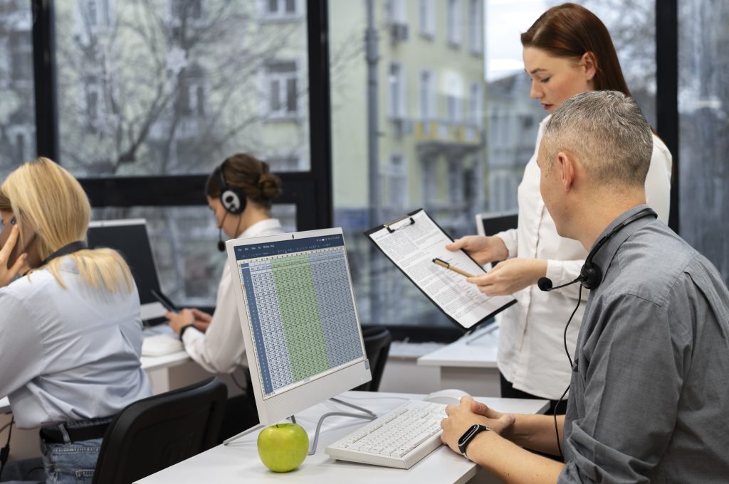 Colleagues working together in a call center office, offshore medical scheduling team