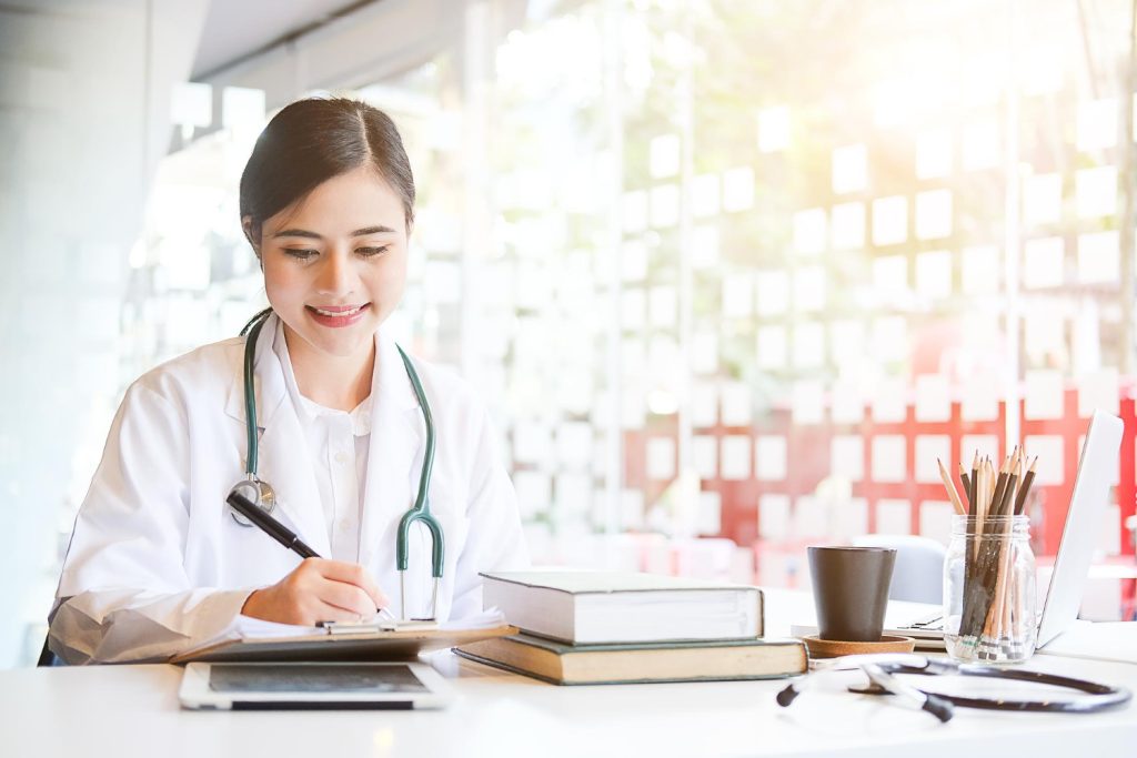 A medical scribe writing patient info