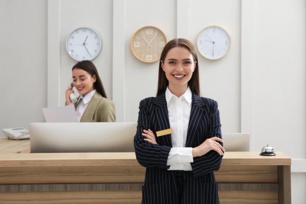 Beautiful receptionist smiling at clients