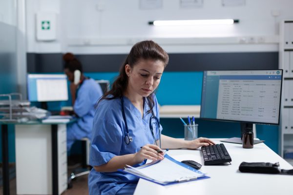 Medical receptionist managing an appointment.