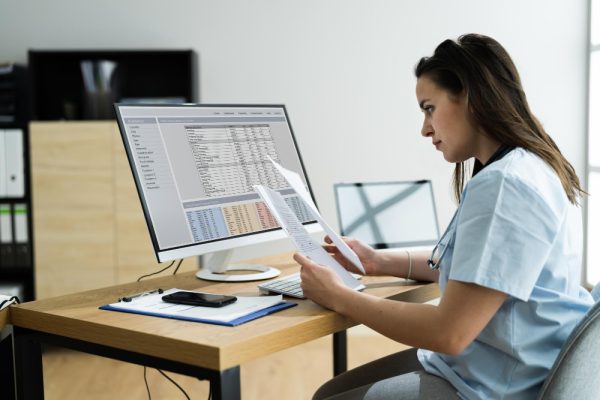 Medical scribe working on medical receords.