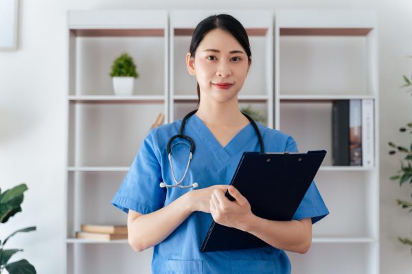 Medical virtual assistant in the Philippines confidently standing with stethoscope in office.
