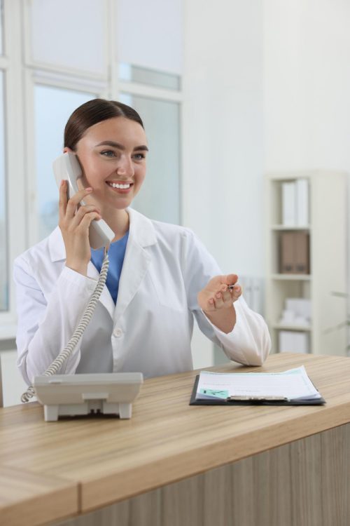Professional receptionist talking on phone
