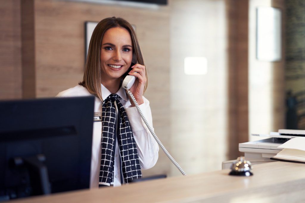 Receptionist answering phone as one of her duties