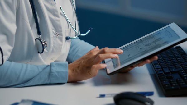 Receptionist using digital tools for electronic health records.