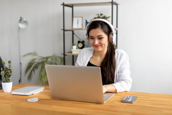 Smiley female medical assistant typing.