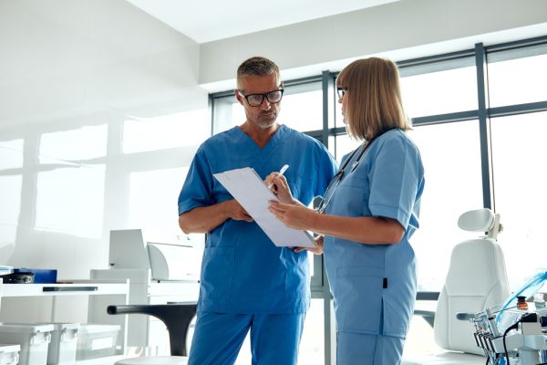 Two patient coordinators collaborating at a medical office.