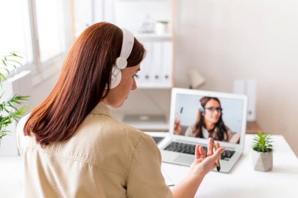 inspiring assistant attending an online interview at home on a laptop.