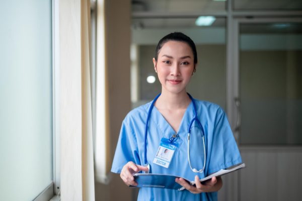 nurse holding folder with documents at hospital.