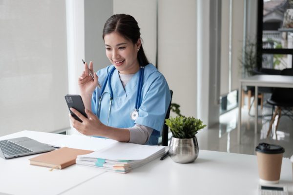 Virtual medical scribe communicating with a client over the phone in a medical office.