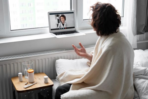 sick young man talking to his doctor online